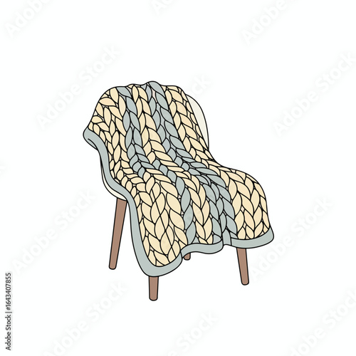 A knitted blanket draped over a simple chair, showcasing a striped design.