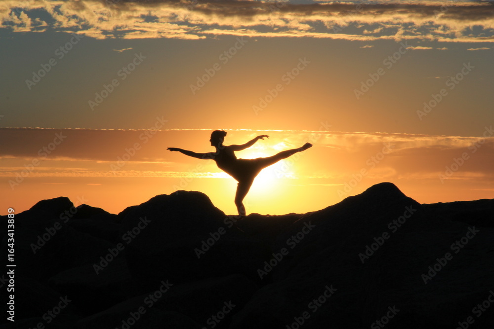 Beautiful girl dancing at sunset on the beach Beautiful girl dancing at sunset on the beach