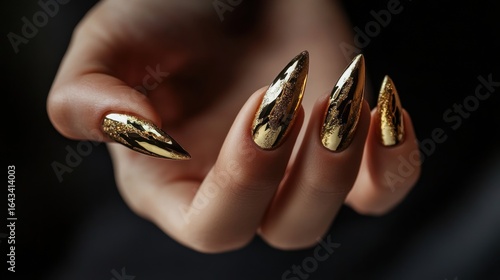 Glamorous Gold Nail Art: Long Pointed Nails with Metallic Finish