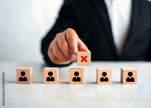 Businessman Rejecting Candidate: Wooden Blocks, Red X, Personnel Selection, Negative Decision, Corporate Hiring, Serious Mood, Close-up.