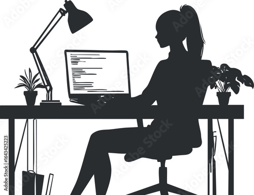 Silhouette of a woman working on a laptop at a desk with a lamp and plants in an office workspace.