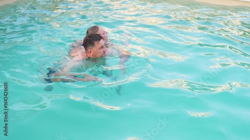 Wallpaper Mural Father and daughter swim in the pool. The concept of a close-knit family. Torontodigital.ca