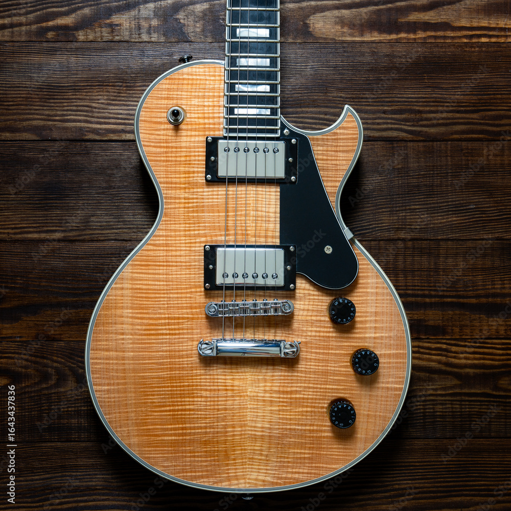 Fototapeta premium Electric guitar with natural pattern isolated on wooden background.