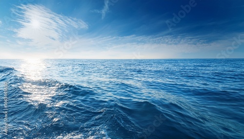 calm ocean waves with sunlight reflections on a clear day serene water surface peaceful nature scene soft blue and white tones aquatic environment