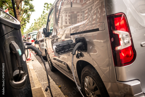 An electric van EV on charge on an urban city street