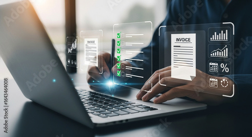 Photo of a professional reviews financial data and invoices on a laptop with a futuristic digital interface