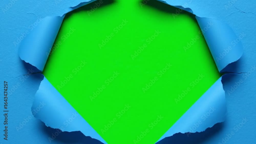 Torn paper hole, blue textured sheet ripped open in diamond shape revealing chroma key green center for design replacement effects in creative video editing and visual projects