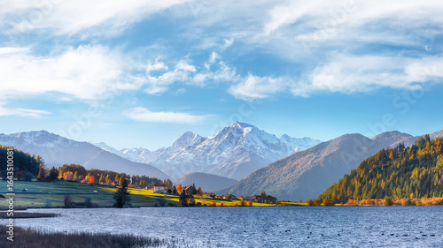 Gorgeous autumn view of Haidersee (Lago della Muta) lake with Ortler peak on background.