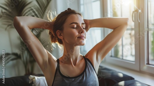 Serene young woman stretches in sunlit apartment, embracing wellness and mindful relaxation at home