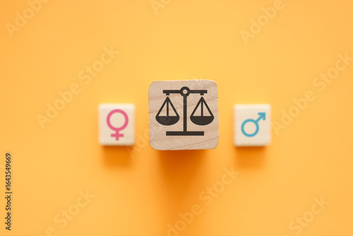 Bild auf Leinwand Gender equality concept with scales of justice between male and female symbols on orange background