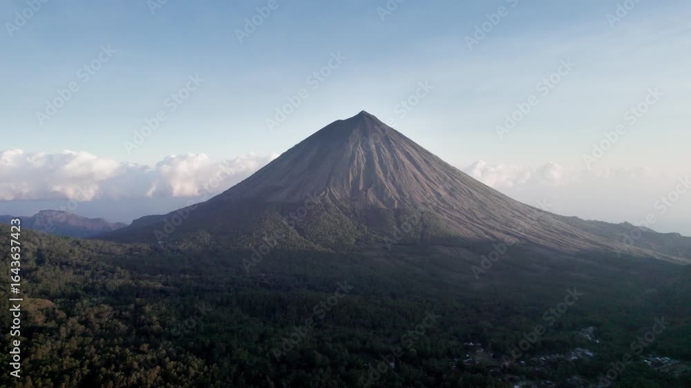 Drone aerial view of Mount Inerie, a striking conical volcano in Flores, Indonesia, surrounded by lush green forest and clear blue skies. Perfect for travel, nature, and documentary.
Drone aerial view of Mount Inerie, a striking conical volcano in Flores, Indonesia, surrounded by lush green forest and clear blue skies. Perfect for travel, nature, and documentary.
