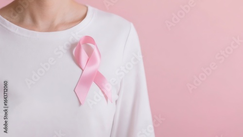 Realistic white shirt with glossy pink breast cancer ribbon close-up, soft gradient background, textured fabric detail for health advocacy