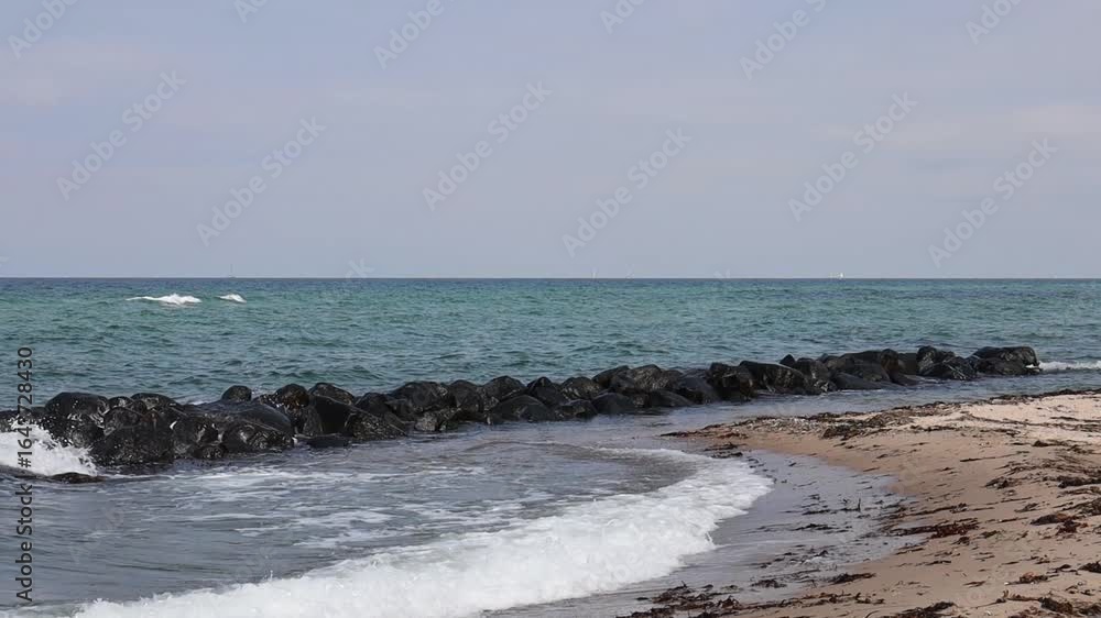 Sea shoreline with rocky breakwater and sky with clouds. FullHD footage Sea shoreline with rocky breakwater and sky with clouds. FullHD footage
