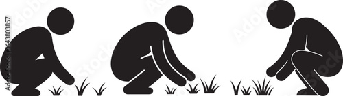 Three figures squatting in grass silhouette