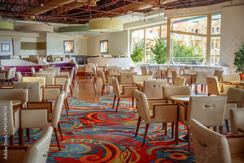 Vibrant dining area with colorful carpet and elegant furniture set in a modern restaurant
