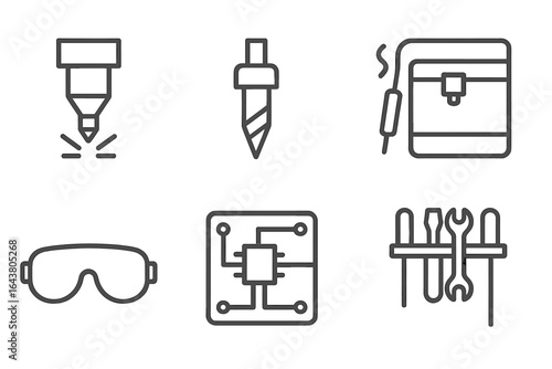 Laser cutter, drill, and tools used in electronics manufacturing at a workshop in the afternoon