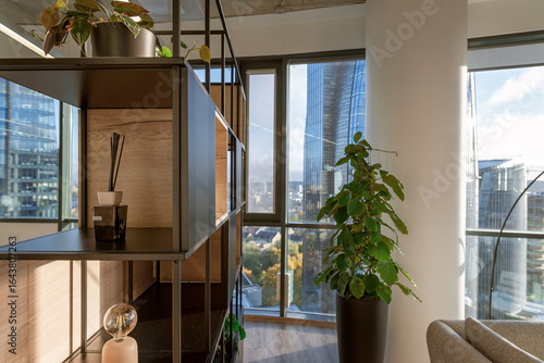 Modern office space featuring stylish decor and large windows with city skyline view during daytime