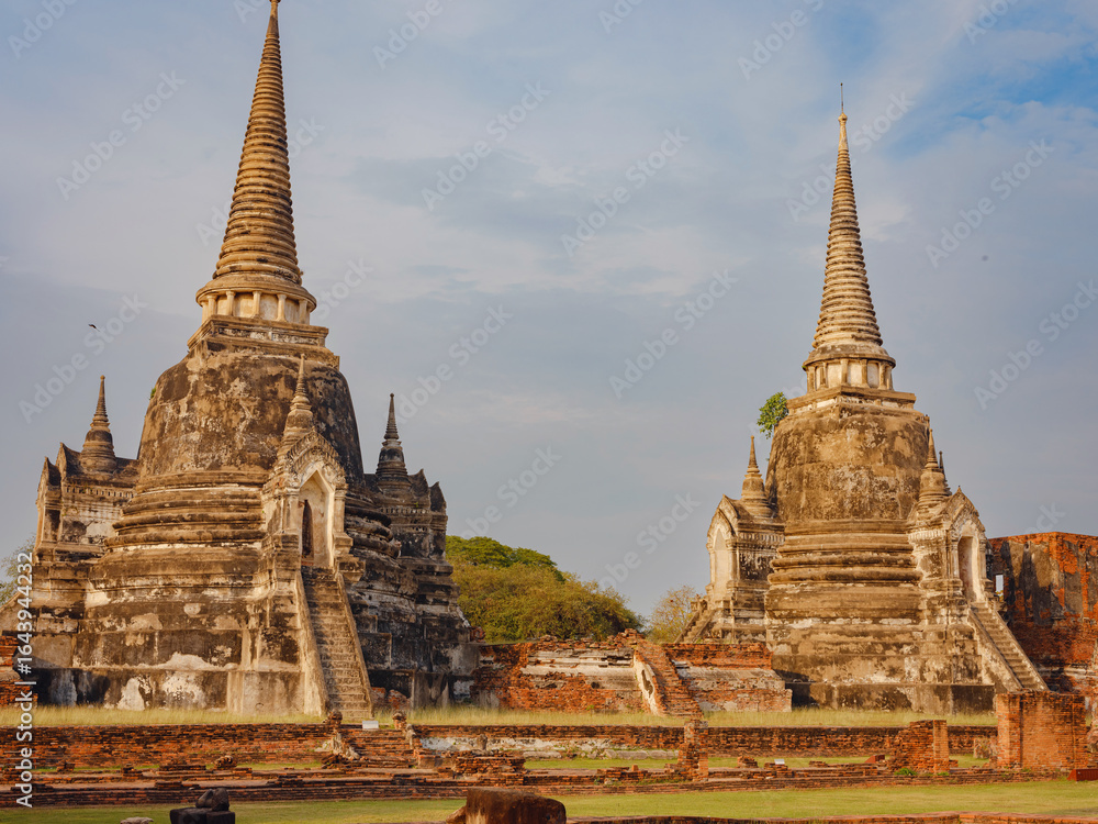 Fototapeta premium Views of Wat Phra Si Sanphet Ayutthaya's ancient templs and landmarks, showcasing intricate architecture, historical ruins, cultural heritage in serene atmosphere of this UNESCO World Heritage site.