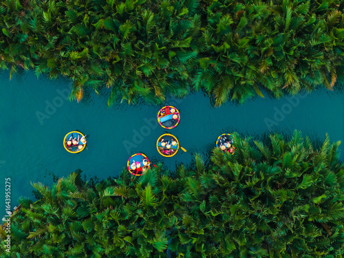 Aerial view of colorful basket boats in lush greenery of hoi an river, vietnam