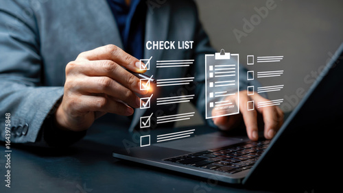 Modern business professional reviewing digital checklist on laptop for project management success