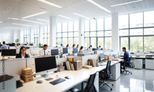 Out of focus, modern office interior with employees working on computers. Ideal for corporate, technology or business projects, conveying a tense atmosphere
