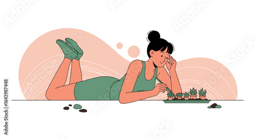 A woman lying down attentively tending to small potted plants with tweezers in a relaxed setting