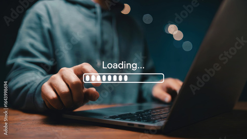Man patiently waiting for data to load on laptop, perfect for technology and internet concepts