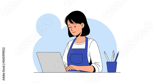 Woman working diligently on a laptop in a creative workspace environment