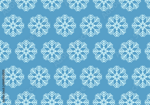 Patrón invernal de copos de nieve en fondo azul