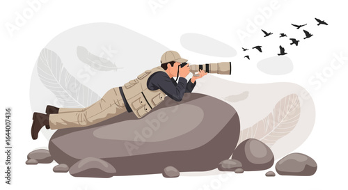 Birdwatcher capturing wildlife with a telephoto lens while lying on a rock in nature