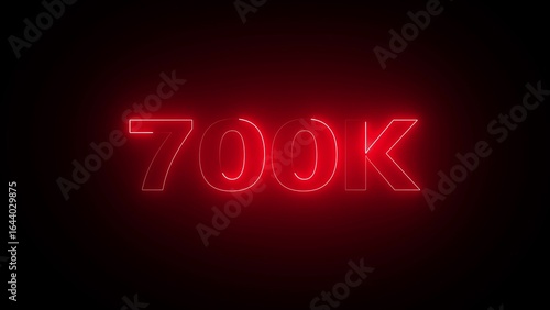 Bright Red Neon 700 K Text Illuminated Against a Dark Background 700k seven hundred thousand