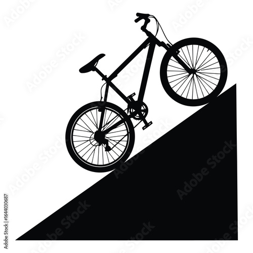 Silhouette of a mountain bike riding down a steep slope
