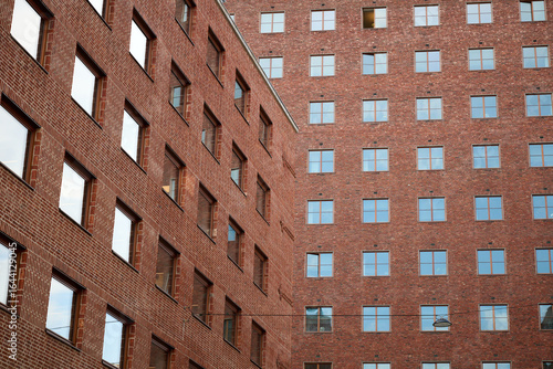 Red Brick Facade of Oslo City Hall with Repeating Window Patterns and Strong Geometric Lines in Urban Courtyard View