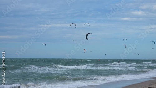 Kitesurfers at Preá Beach, Ceará, Brazil, with colorful kites in the sky, waves and a vibrant seaside sports atmosphere.
