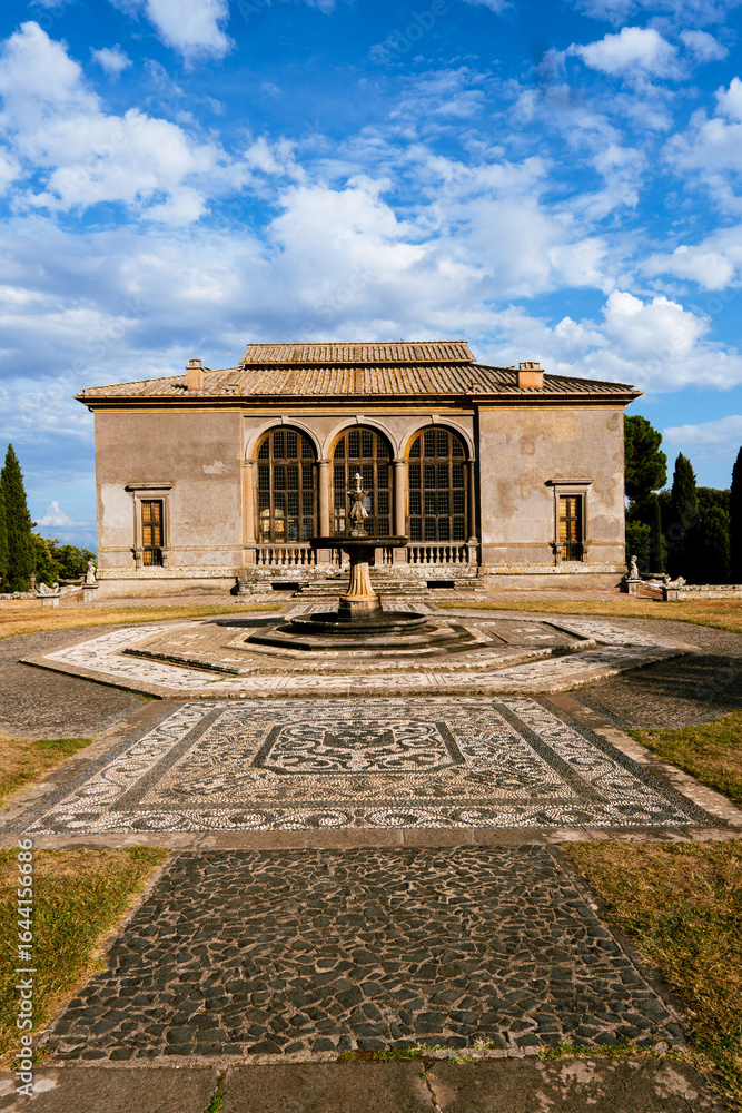 Fototapeta premium Renaissance villa courtyard with stone fountain and decorative mosaic pathway