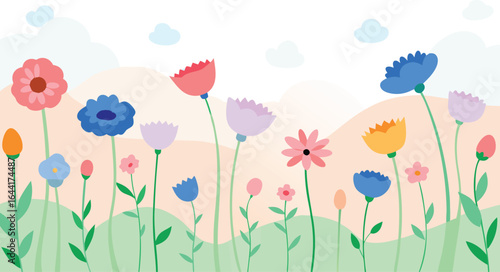 Colorful flower field with a variety of blooms against a blue sky and cloud background