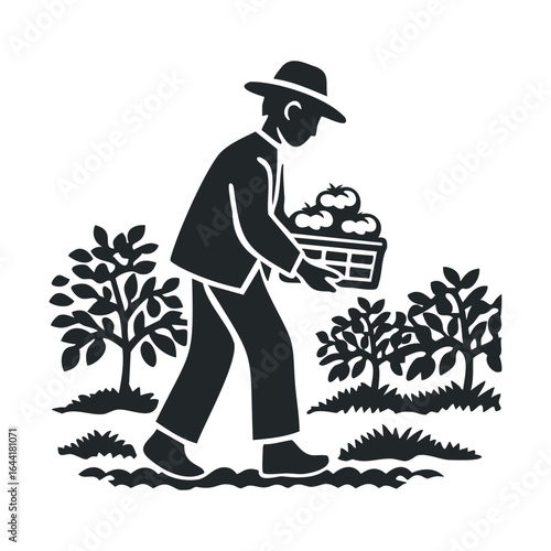 Silhouette of farmer harvesting apples in orchard with basket