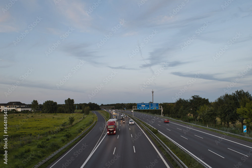 Fototapeta premium Langzeitbelichtung - Autobahn - Strasse - Traffic - Travel - Background - Line - Ecology - Highway - Long Exposure - Motorway - Night Traffic - Light Trails - Vacation - Sunset - High quality photo