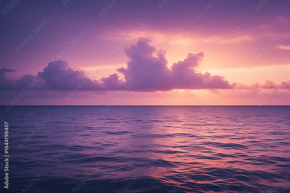 Obraz premium Orange light from the rising and setting sun reflects beautifully on the water of the ocean, painting the clouds and sky in shades of red and blue