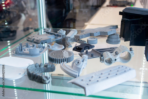 Objects printed on 3D printer from molten plastic powder. Different models printed on 3D printer from melted grey polyamide powder. Multi Jet Fusion MJF technology. New additive 3D printing technology
