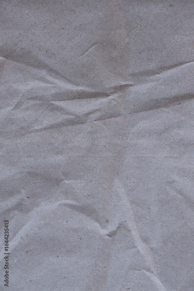 Naklejka premium Brown crumpled recycled paper texture background. Kraft Paper