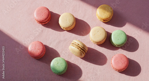top view of delicious French macaroons on pink background with copy space, panoramic shot