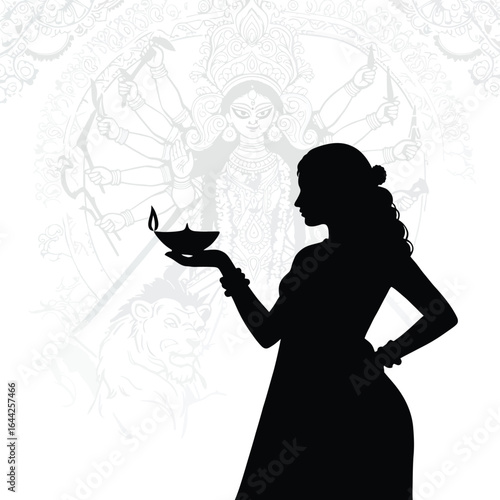 Silhouette of Indian woman holding diya lamp celebrating Durga Puja festival with goddess Durga and lion in background representing strength and victory of good over evil