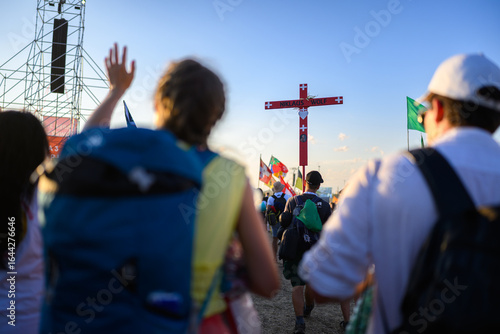 A girl walking past and greeting groups of young people at the Tor Vergata camp during the Youth Jubilee with Pope Leo XIV.