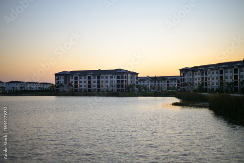 sunset over the apartment complex lake