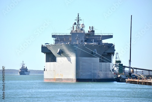 Large naval ship in port