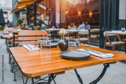 Photography Outdoor empty coffee and restaurant terrace with potted plants tables and chairs