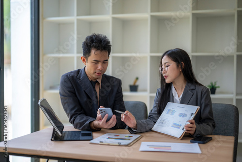 Wallpaper Mural Asian businesspeople discussing work using charts and smartphone in office Torontodigital.ca