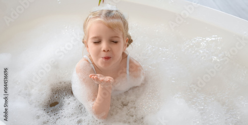 Cute little girl with foam ...