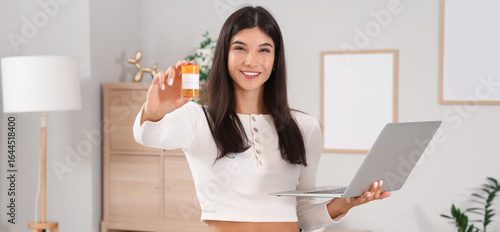 Young woman with laptop and...